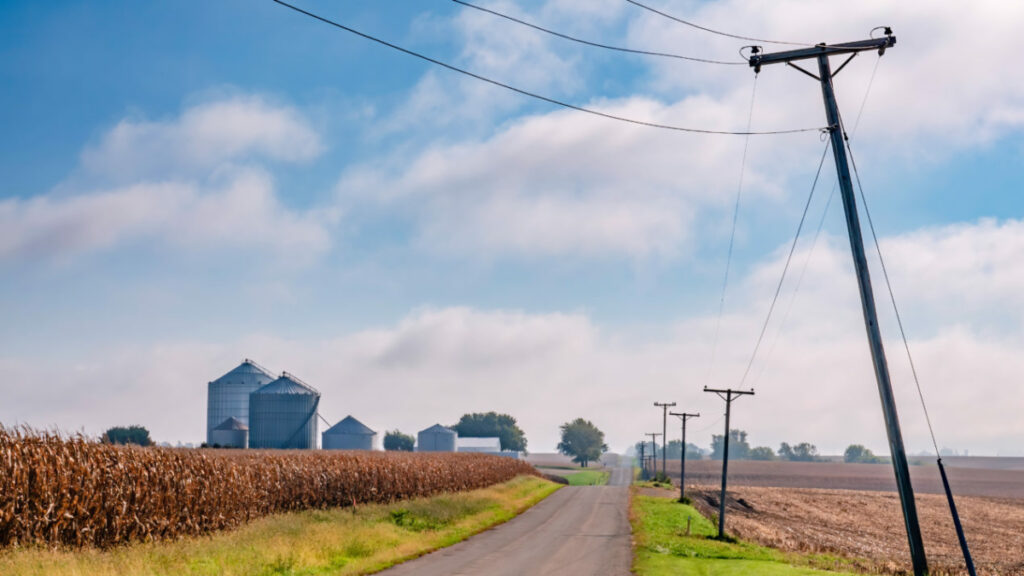 Rural road farm Wisconsin grain bins electric power lines corn field
